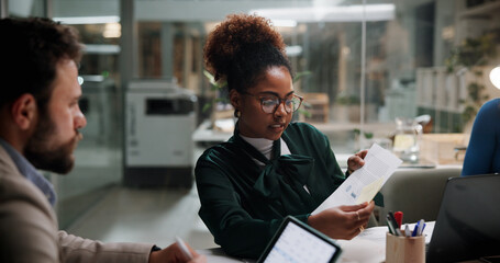 Poster - Business people, paperwork and discussion in office for finance, budget information or planning at night. Admin staff, document and overtime in agency with profit projection, briefing or review offer