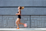 Young woman jogging outdoors, motion concept