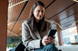 © Westend61 - Entrepreneur woman checking her mobile phone indoors