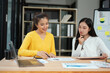 © panomporn - Two businesswoman hands or accountants working together on financial investment on calculator, calculating, analyzing business growth and marketing on graph.