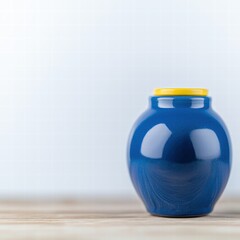 Poster - A striking blue vase on a simple table adding a touch of color and elegance to the room decor