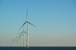 © Westend61 - Offshore wind turbines at the end of the day over the ocean