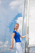 © danmorgan12 - Sea Travel Concepts. One Winsome Happy and Smiling Positive Caucasian Sailor Woman Standing Relaxing on White Yacht At Daytime on Board.