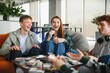 © Serhii - Happy friends playing board game in modern office