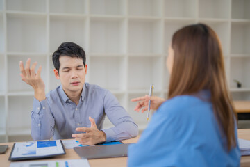 Aufkleber - Two asian businesspeople discussing about negative financial report, businessman is stressed and gesturing with hands while having a difficult conversation with his colleague