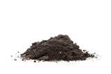 A mound of dark soil or dirt isolated against a plain black background in a studio setting view