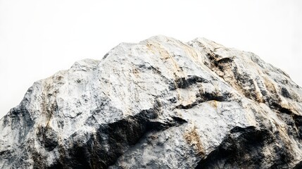 Poster - A close up view of a large rock formation with visible texture and a bright white background space above