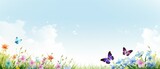 Niebieskie niebo, kolorowe kwiaty i motyle