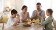 © New Africa - Family praying together before dinner at table indoors