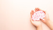 © Orawan - Woman hands holding human brain shape made from paper on beige background. Awareness of Alzheimer, Parkinson's disease, dementia, stroke, seizure or mental health. Neurology and Psychology care.