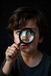 © Bass - Curious Child Looking Through Magnifying Glass – Close-Up Portrait