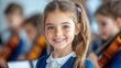 © Raul - Smiling young girl is posing for a portrait in her school orchestra classroom with violin players visible in the background.