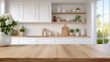 © Nati - Smooth wooden tabletop, out-of-focus modern kitchen, warm tones, cozy interior feel
