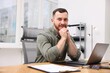 © New Africa - Handsome man working at desk in office