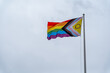 © Joose - Pride Flag Displayed Proudly Against Pale Sky on Bright Day