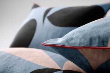Poster - Decorative pillows arranged artfully on a modern couch in a minimalist living room showcasing contemporary design elements
