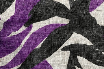 Poster - Vibrant purple and black patterned fabric draped gracefully across a table in bright daylight