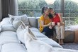 © Wavebreak Media - Elderly woman comforting young woman on couch, both holding coffee mugs