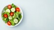 © Ravanas Arts - Healthy green salad with cucumber and cherry tomatoes.  Concept of diet, nutrition, and healthy eating.