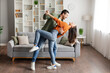 © Home-stock - Romantic young husband and wife dancing, having fun at home, enjoying domestic date, living room interior, full length. Happy marriage concept