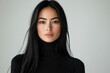 © Vibudhaart - A young woman with long black hair, wearing a black turtleneck, looks directly at the camera.