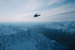 © Echt&KIreativ - Helicopter flying over snowy mountain peaks in winter