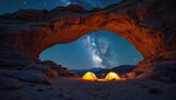 Night scene camping under Wolfberg Arch, two tents under starry sky, galaxy. Majestic sandstone rock formation, canyon landscape, adventure travel. Night sky with stars, Milky Way. Desert, hiking,