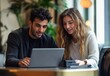 © sunny - young man and woman sitting in a cozy indoor space looking at a tablet together with interest and smiles around them