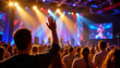 © Atchariya63 - Worshippers raise their hands in praise during vibrant Christian worship service filled with colorful lights and music