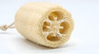 © Photqeey - A close-up of a loofah sponge with soft backlight and clean white background