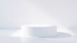 © Rafi - Hexagon-shaped white podium under angled natural light casting soft hexagonal shadows on white surface