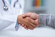 © StockHive - Doctor and patient shaking hands in consultation.