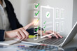 © Supapich - Close-up hand businessman doing checklist document survey list quality questionnaire choice form mark concept