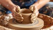 © DZIKRA  - Muddy hands shaping clay on a pottery wheel forming a pot. Crafts, hobby, creation