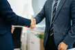 © Nuttapong punna - wo confident business man shaking hands during a meeting in the office, success, dealing, greeting and partner