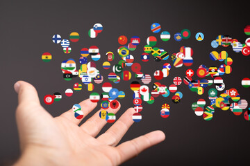 Poster - Image of a hand with many flags representing global connections and international collaboration.