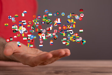 Aufkleber - Image of many national flags floating above an open hand, symbolizing global unity and connection.