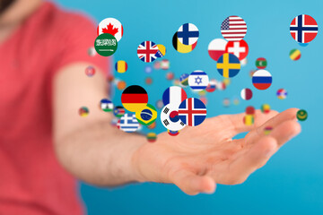 Poster - Diverse flags floating towards an outstretched hand, symbolizing global reach and international collaboration.