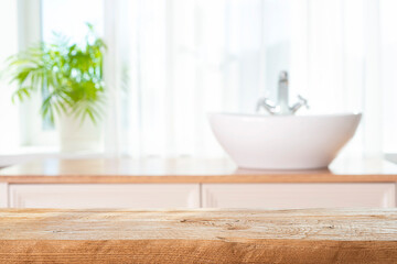 Wall Mural - wooden table top for product presentation on blurred bathroom window interior background