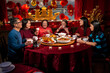 © Christina - Smiling family enjoying Chinese New Year dinner in restaurant