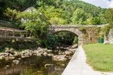 Rural landscape with a Roman bridge and a rural stone house overlooking the river