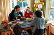© Christina - Mother and three children dining during Eid Celebration