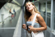 © JackF - Thoughtful young woman listening to music on headphones while looking for train