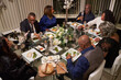 © Christina - Group of friends dining while celebrating wedding anniversary