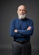© Talha - Portrait of a serious older man with a beard and arms crossed in a studio setting image