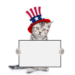 Poster - Cute kitten wearing like Uncle Sam looks at camera and shows blank whie board. isolated on white background
