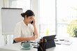 © Fahng - Interior designer talking on cellphone with client, discussing new project, In studio office with blueprint drawing color swatches and material, design develop, Copy Space