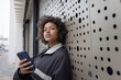 © ReeldealHD images - Young woman Checking Phone in Urban Setting