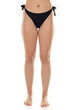 © vladimirfloyd - Close-up view of woman wearing black bikini bottom with side ties against white background, natural figure, swimwear fashion detail, lower body portrait