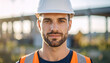 © hardvicore - Portrait of guy in protective helmet, blurred construction site on backdrop. Young man, worker.